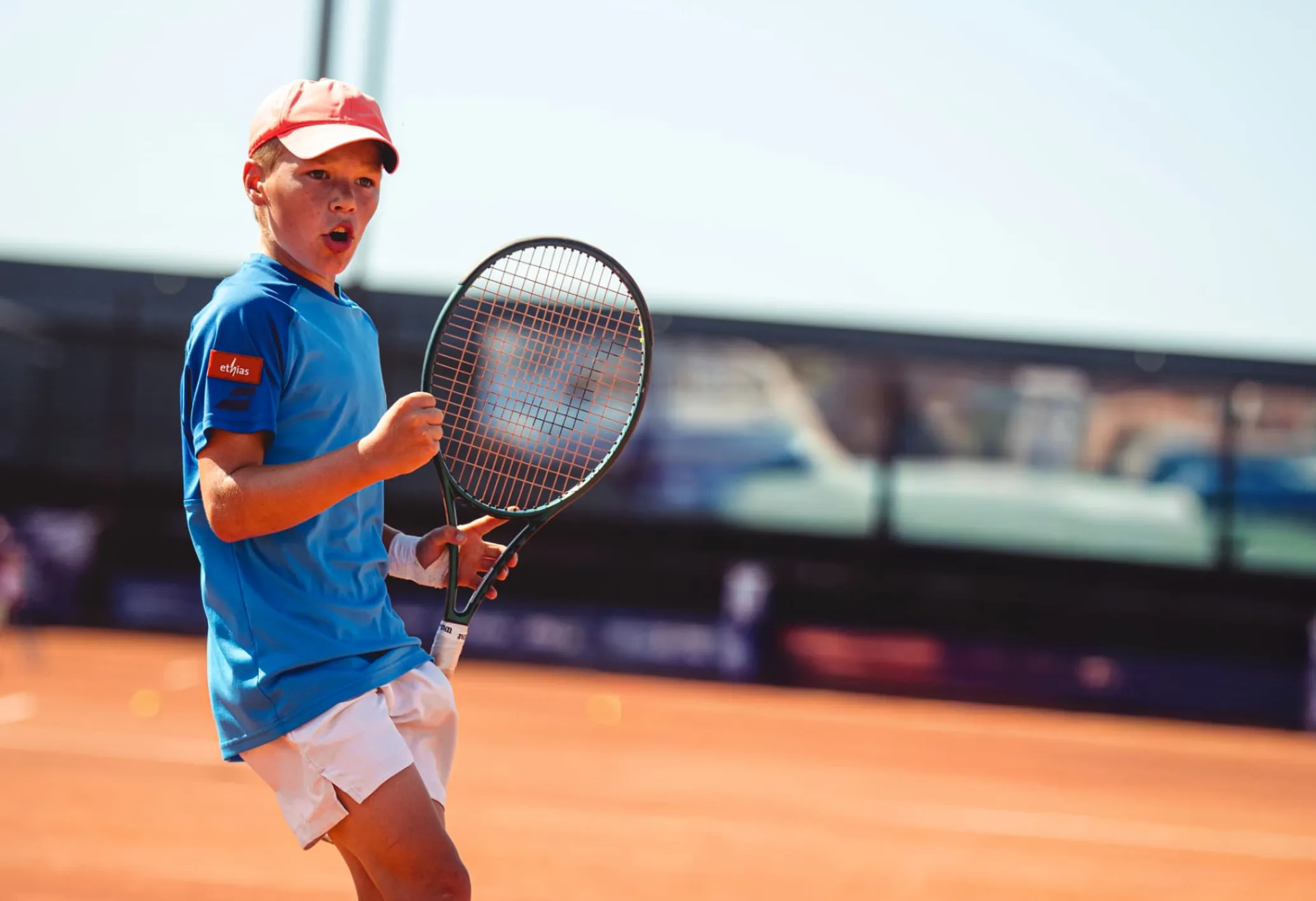 A young man plays tennis