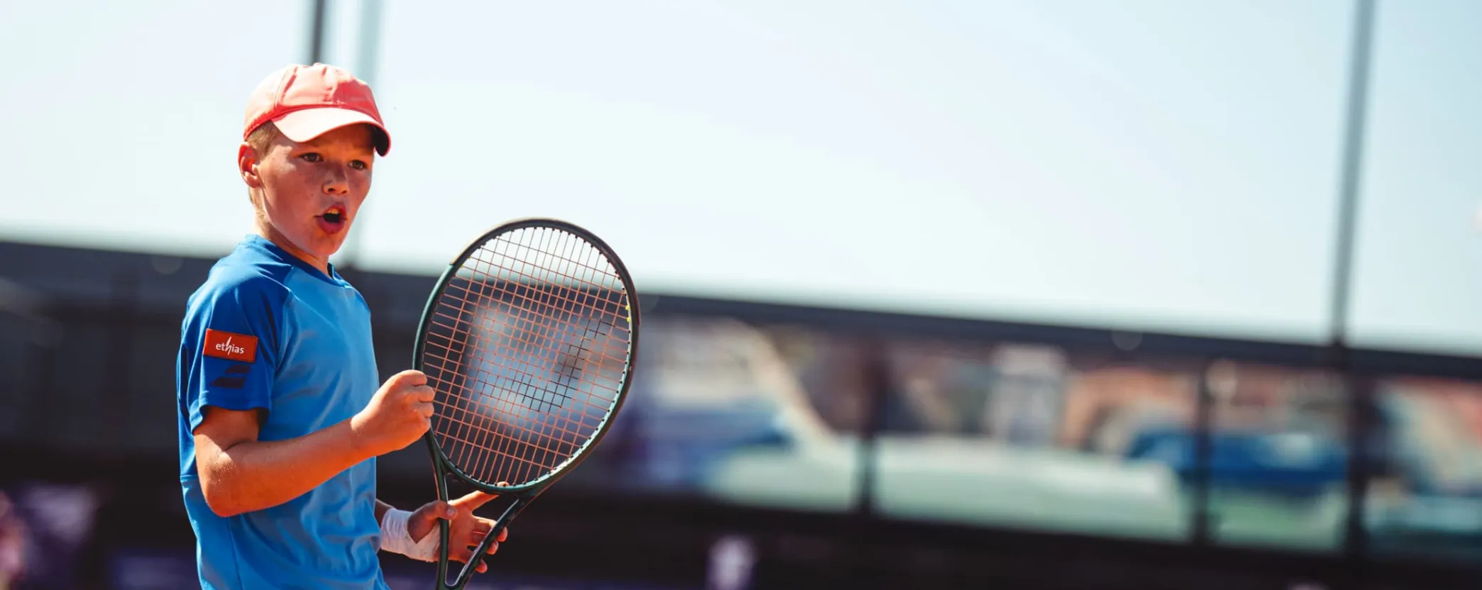 A young man plays tennis
