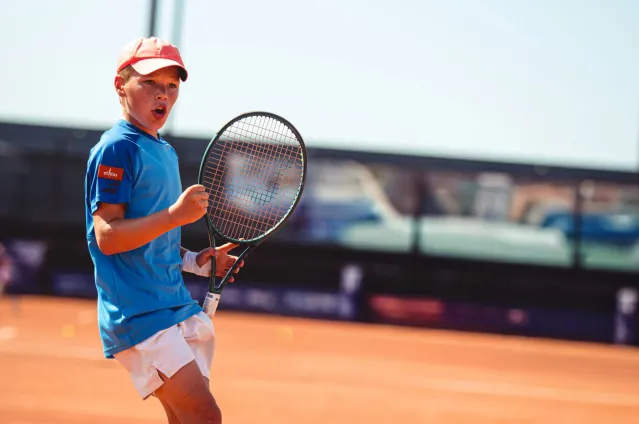 A young man plays tennis
