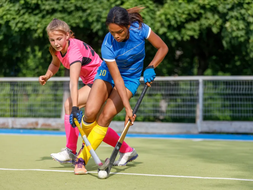 2 girls playing hockey